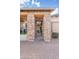 Inviting front entry featuring stone pillars, covered walkway, and well-maintained landscaping at 20981 E Watford Dr, Queen Creek, AZ 85142