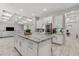 Open floor plan reveals coffered ceilings and a kitchen with a granite island and stainless steel refrigerator at 20981 E Watford Dr, Queen Creek, AZ 85142