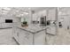 Open concept kitchen with granite countertops, white cabinetry, stainless steel refrigerator, and coffered ceilings at 20981 E Watford Dr, Queen Creek, AZ 85142