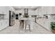 Bright kitchen featuring white cabinets, stainless steel appliances, mosaic backsplash, and a large center island at 20981 E Watford Dr, Queen Creek, AZ 85142