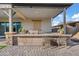 Charming outdoor kitchen with a built-in grill and bar area, great for entertaining at 20981 E Watford Dr, Queen Creek, AZ 85142