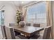 Elegant dining room with a large wooden table, comfortable gray chairs, and a bright window, perfect for Gathering meals at 21032 N 58Th St, Phoenix, AZ 85054