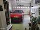 Organized garage with a modern red car, bicycle, and ample storage space at 2150 E Bell Rd # 1048, Phoenix, AZ 85022