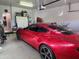 Well-maintained garage showcasing a sleek red car and functional storage solutions at 2150 E Bell Rd # 1048, Phoenix, AZ 85022