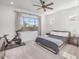 Cozy bedroom featuring neutral carpet, ceiling fan, and large window for ample natural light at 21757 S 191St Pl, Queen Creek, AZ 85142