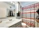 Bathroom featuring stylish vanity, mirror, and bathtub with a charming moose-themed shower curtain at 2202 N Los Altos Dr, Chandler, AZ 85224