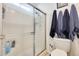 Bathroom featuring a clear shower door, blue towels and a dual flush toilet at 2202 N Los Altos Dr, Chandler, AZ 85224