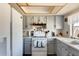 Well-lit kitchen featuring white appliances, a window, and ample storage within the cabinetry at 2202 N Los Altos Dr, Chandler, AZ 85224