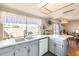 Bright kitchen with a window overlooking the backyard, white cabinets, and modern appliances at 2202 N Los Altos Dr, Chandler, AZ 85224