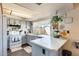 Well-lit kitchen featuring white cabinets, countertops, and a window offering backyard views at 2202 N Los Altos Dr, Chandler, AZ 85224