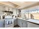 Bright kitchen with white appliances, light-colored cabinetry, and a view to the yard at 2202 N Los Altos Dr, Chandler, AZ 85224