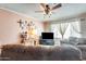 Cozy living room showcasing a ceiling fan, natural light, and comfortable, oversized furniture at 2202 N Los Altos Dr, Chandler, AZ 85224