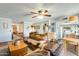 Spacious living room with a large sofa, a ceiling fan, and views into the kitchen and dining room at 2202 N Los Altos Dr, Chandler, AZ 85224