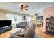 Spacious living room featuring hardwood floors, a cozy seating area, and an adjacent dining area at 2202 N Los Altos Dr, Chandler, AZ 85224