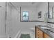 Bright bathroom with a shower, toilet, and modern vanity with black countertop at 2209 N 23Rd St, Phoenix, AZ 85006