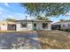 Charming single-story home with a desert landscape, concrete driveway, and bright blue-green front door at 2209 N 23Rd St, Phoenix, AZ 85006