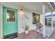 Inviting front porch with a blue-green door, welcome mat, potted plant, and a comfortable bench at 2209 N 23Rd St, Phoenix, AZ 85006