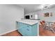 Kitchen area showing vintage-style turquoise cabinets, stainless counters, and a functional layout at 2209 N 23Rd St, Phoenix, AZ 85006