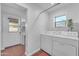 Well-lit laundry room with modern washer and dryer and functional shelving at 2209 N 23Rd St, Phoenix, AZ 85006