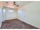 Bright bedroom with a neutral color scheme, ceiling fan, and plush carpet flooring at 2209 N 8Th St, Phoenix, AZ 85006