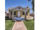 Charming bungalow with a brick walkway, freshly cut green grass, and cozy front porch at 2209 N 8Th St, Phoenix, AZ 85006