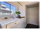 Bright laundry room featuring a window, washer, dryer, and convenient storage nook at 2209 N 8Th St, Phoenix, AZ 85006