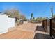 Large backyard featuring wood deck, storage shed, and spacious gravel area at 2237 N 9Th St, Phoenix, AZ 85006