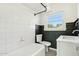 A classic black and white bathroom featuring tile floors, a tub, and a sink with vanity at 2237 N 9Th St, Phoenix, AZ 85006