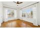 A bright bedroom featuring hardwood floors and large windows with sheer white curtains at 2237 N 9Th St, Phoenix, AZ 85006