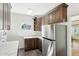 Cozy kitchen featuring stainless steel appliances, white countertops, and dark wood cabinetry at 2237 N 9Th St, Phoenix, AZ 85006