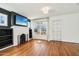 Cozy living space featuring a fireplace, hardwood floors, and a ceiling fan at 2237 N 9Th St, Phoenix, AZ 85006