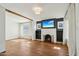 Spacious living room featuring hardwood floors, beamed ceiling, and a charming fireplace at 2237 N 9Th St, Phoenix, AZ 85006