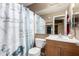 Bathroom featuring a novelty shower curtain and a wood vanity with a large mirror at 2251 E Remington Pl, Chandler, AZ 85286