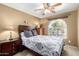 Bright bedroom featuring a ceiling fan, neutral carpet, and plenty of natural light at 2251 E Remington Pl, Chandler, AZ 85286