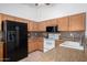 Bright kitchen featuring wood cabinets, white appliances, and laminate countertops for functional cooking space at 2251 E Remington Pl, Chandler, AZ 85286