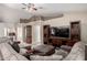 Spacious living room featuring a large sectional sofa, entertainment center, and neutral color scheme at 2251 E Remington Pl, Chandler, AZ 85286