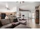 Open-concept living room with tile floors, neutral color palette, and seamless flow to the kitchen at 2251 E Remington Pl, Chandler, AZ 85286