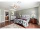 Serene main bedroom with hardwood floors, ceiling fan, en-suite bathroom, and neutral tones at 2251 E Remington Pl, Chandler, AZ 85286