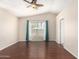 Bedroom with wood floors, neutral paint, and large window with curtains for natural light at 2263 E Mariposa Grande --, Phoenix, AZ 85024