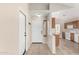 Bright entryway features tile flooring and a view into the kitchen with white appliances and wooden cabinets at 2263 E Mariposa Grande --, Phoenix, AZ 85024