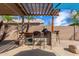 Covered outdoor kitchen bar with stone accents and seating offers backyard dining at 2263 E Mariposa Grande --, Phoenix, AZ 85024