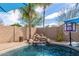 Rock waterfall feature in the backyard pool with lush tropical landscaping at 2263 E Mariposa Grande --, Phoenix, AZ 85024