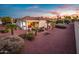 Spacious backyard with covered patio, desert landscaping, and a cozy seating area for outdoor enjoyment at 23318 N Las Positas Ct, Sun City West, AZ 85375