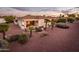 Aerial view of a backyard featuring a covered patio and desert landscaping at 23318 N Las Positas Ct, Sun City West, AZ 85375