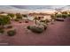 Aerial view of a backyard featuring a covered patio and desert landscaping at 23318 N Las Positas Ct, Sun City West, AZ 85375