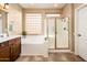 Bright bathroom with a soaking tub, separate shower, and modern fixtures, and plenty of natural light at 23318 N Las Positas Ct, Sun City West, AZ 85375