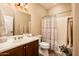 Clean bathroom featuring a dual sink vanity and shower with a curtain rod at 23318 N Las Positas Ct, Sun City West, AZ 85375