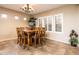 Bright dining room with a chandelier, large windows, and a spacious dining table at 23318 N Las Positas Ct, Sun City West, AZ 85375