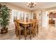 Elegant dining room featuring a wooden table with seating for eight near arched doorway at 23318 N Las Positas Ct, Sun City West, AZ 85375