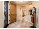 Inviting foyer featuring tile flooring, an ornate front door, and stylish decor at 23318 N Las Positas Ct, Sun City West, AZ 85375